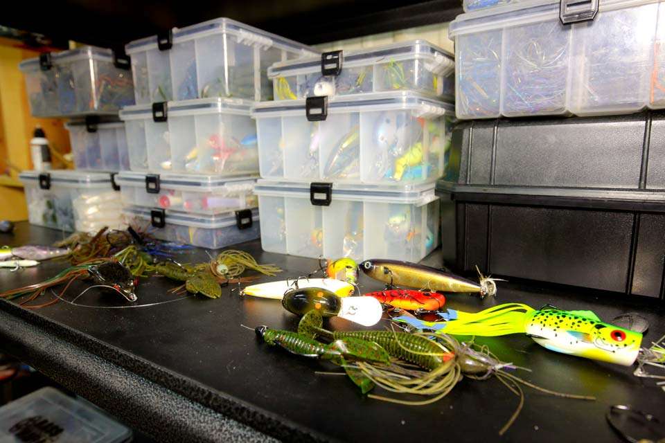 Shelving units hold a plethora of tackle boxes filled to the max with tackle, easy to see and easy to grab.
