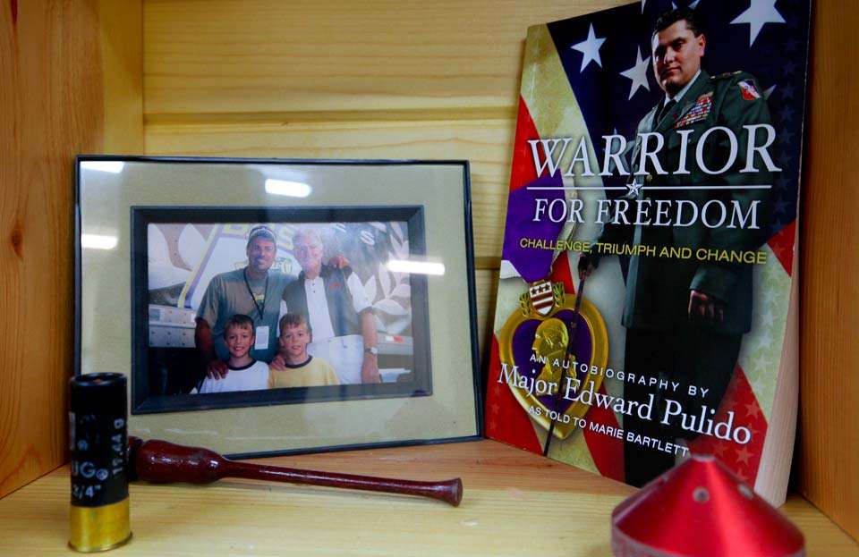 And thereâs a photo of him and his sons with Jerry McKinnis, along with an inspirational book, a turkey striker, a shotgun shell and a TH Marine Prop Nut.  It is almost the most interesting grouping of things in the whole Man Cave.
