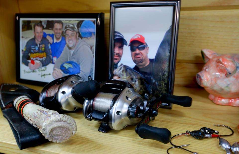 Until you see the next shelf with a photo of Zona, Kevin VanDam and Louie Stout next to a sour-faced photo of Zona and behind a sheathed knife with an antler handle, a couple of reels, with some scattered jig heads and some sort of pink pig.

