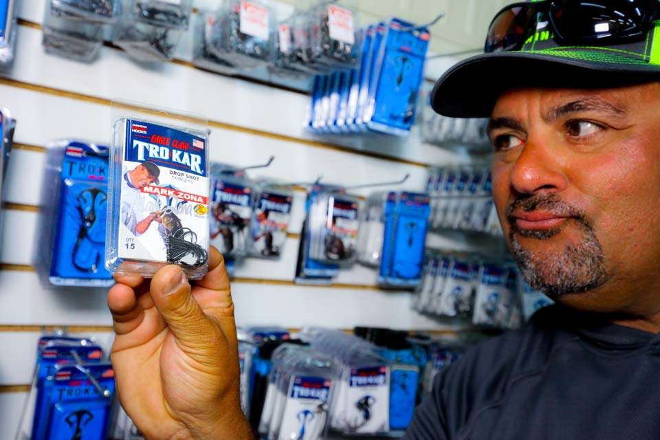 At the end of his tackle rack is a store of Trokar Hooks, including those with his name and face on them.

