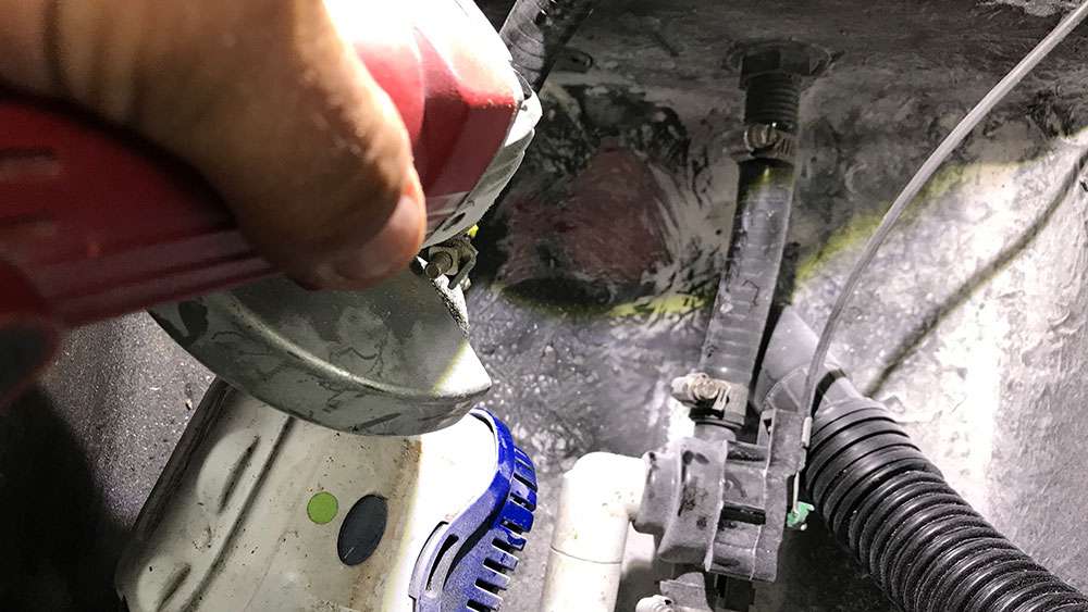 Once I had the area cleaned and dried, I used a hand grinder to remove the old adhesive, which came right off. I also lightly cleaned the area where the new transducer was to go. Be careful to not accidently hit your livewell infrastructure, or youâll have another unwelcomed issue to resolve. 