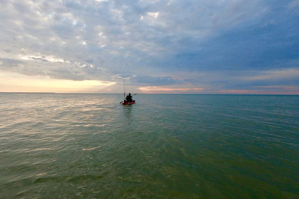 The colors of summer paint a Lake Erie canvas. The kayaker ventures forth in search of bronze bass.