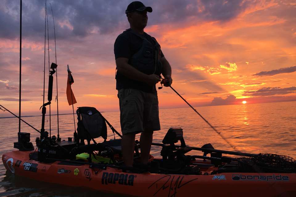 Throwing some final-light topwater and hoping for a blowup against the flooded, blood-orange sky.