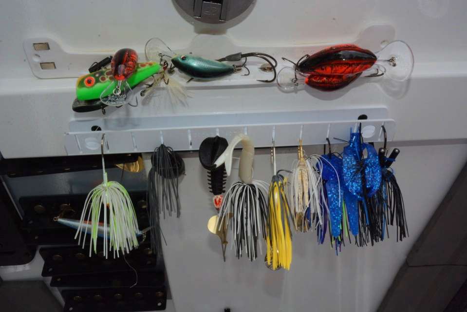 Beneath the lid is the T-H Marine Tackle Titan lure and tool organizer for frequently used baits. Lures are attached by looping hooks through the slotted part. 
