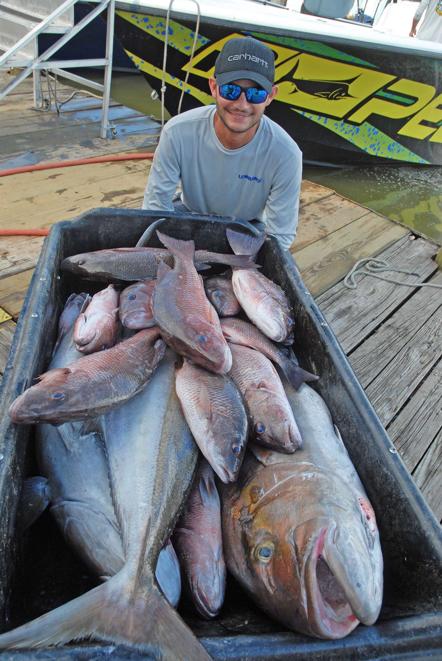 A pile of mangrove snapper and enormous amberjack fill the fish cart.