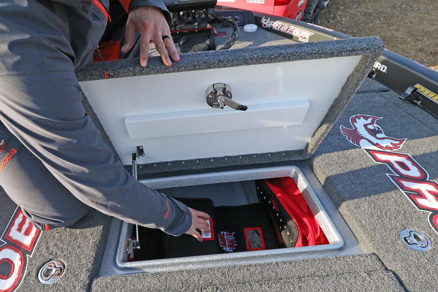 Beneath the front storage compartment lid are some very necessary items stowed inside some handy Bass Mafia soft-side bags. 