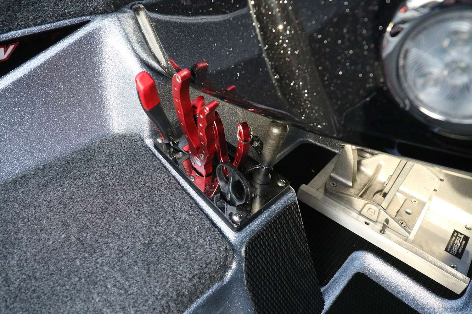 And conveniently placed just beneath the driver console is a small tool rack. Here he keeps a myriad of fish care tools and pliers. 