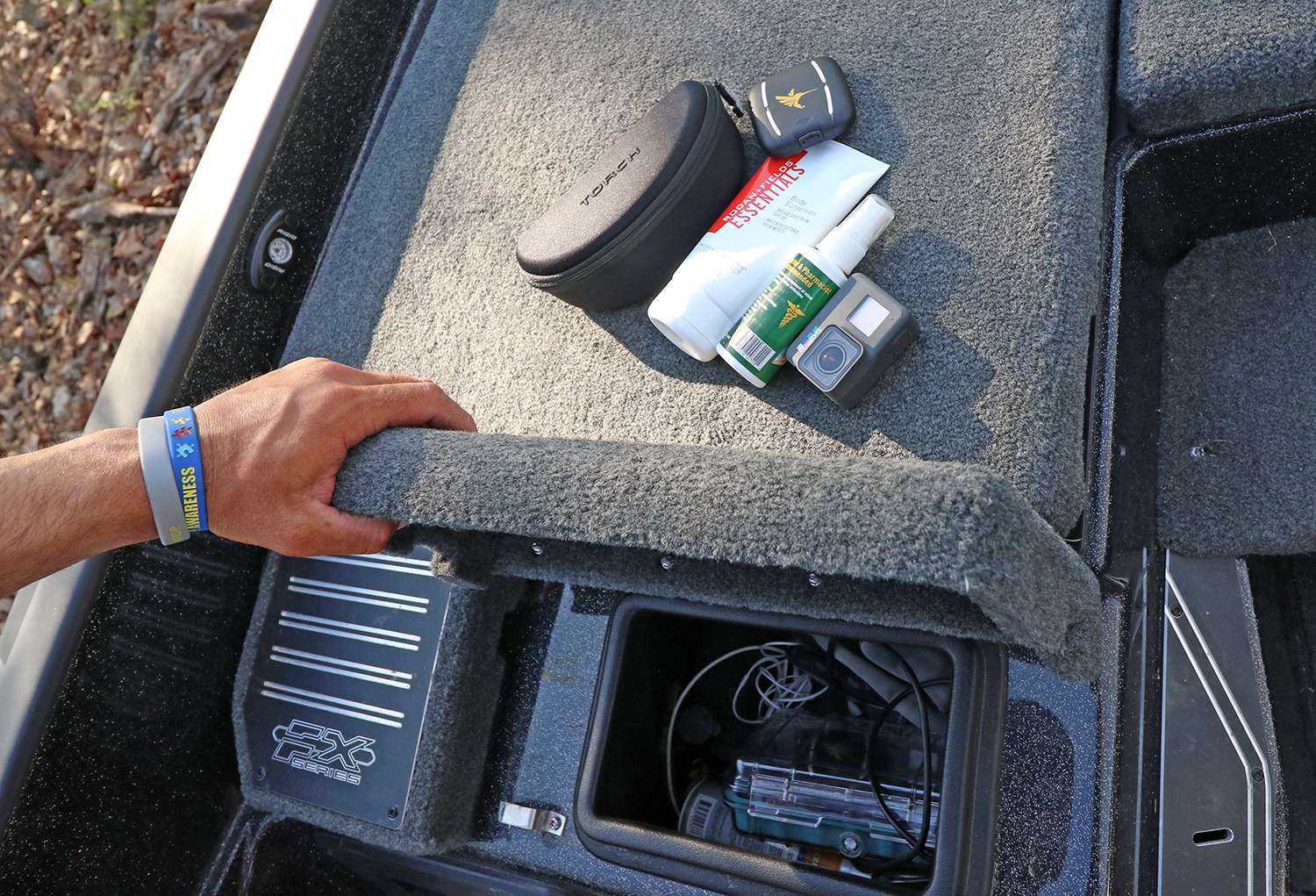 In front of the passenger seat is a small storage box that keeps other necessities handy like LakeMaster cards, a GoPro, sunblock, sunglasses and other items.