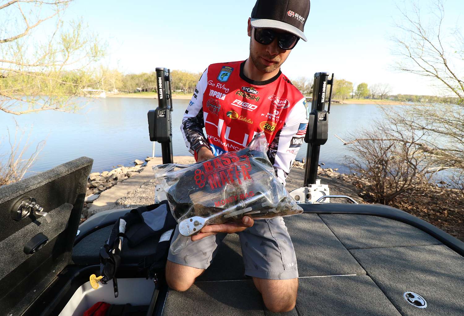 This Bass Mafia plastic bag is nearly bullet proof. Here he keeps tools that he might need while on the water. 