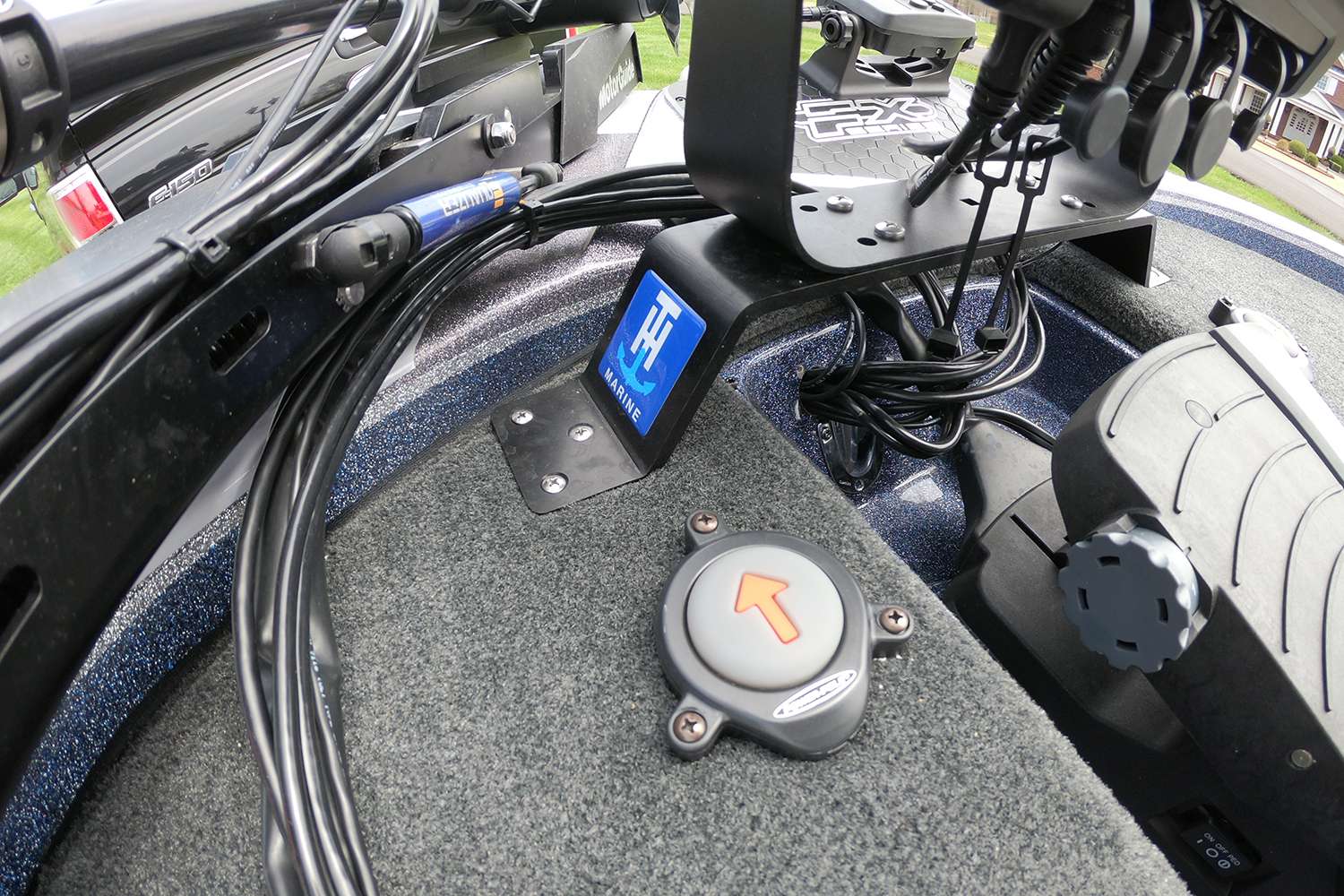 To the left of the trolling motor pedal is a Power-Pole button and a look at the mounting base for his Garmin electronics.