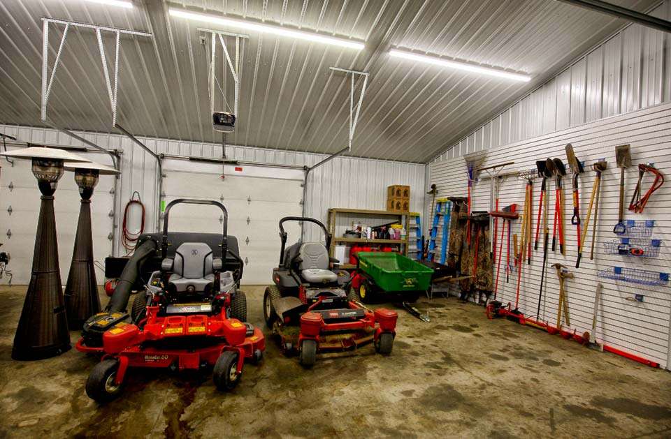 On the opposite end of the shop are two lawnmowers and a variety of yard tools to help keep his oasis clean and neat. 
