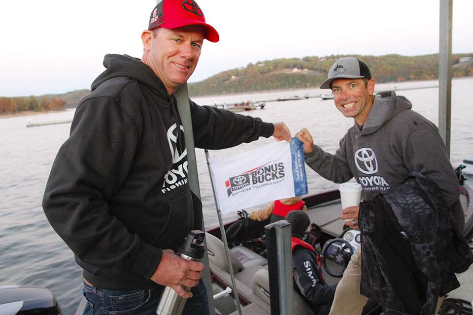 Kevin VanDam and Mike Iaconelli show off the flag on this competitors light pole.