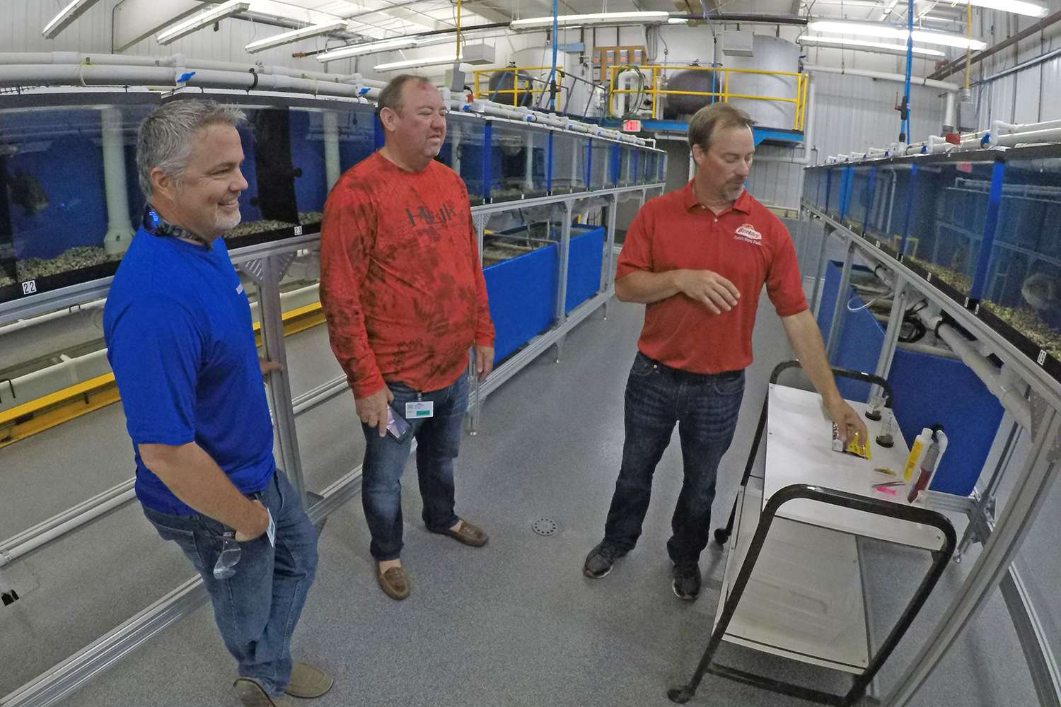 Now we move into the testing facility. James Hall on the far left is joined by B.A.S.S. CEO Bruce Akin and legendary angler and bait tester Mark Sexton on the right. Mark has the best job in the world, period. 