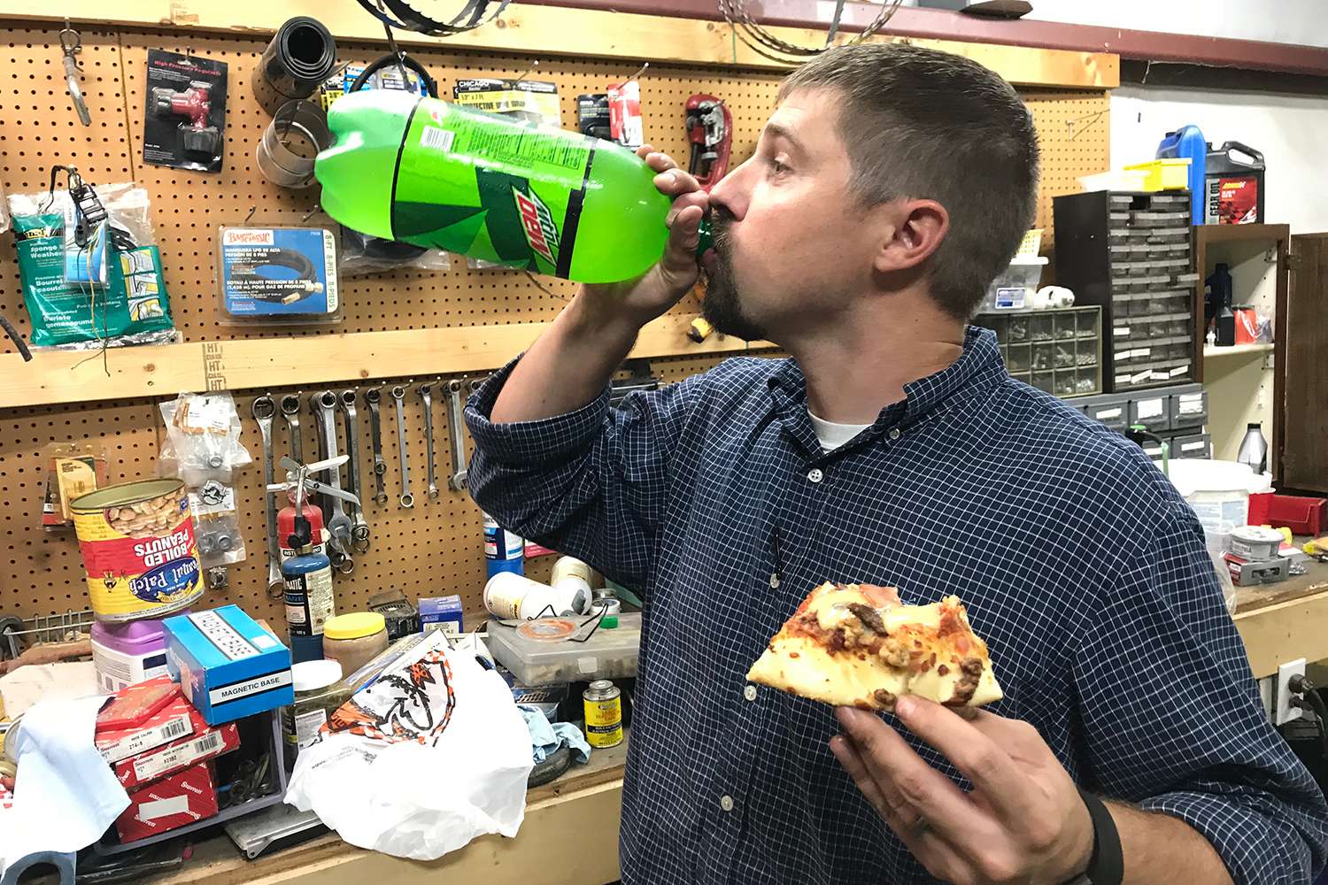Paul decides to power up on a 2-litre of Mt. Dew. This man is for real, folks. He doesn't mess around when it comes to detailed DIY projects. Every piston needs fuel. 