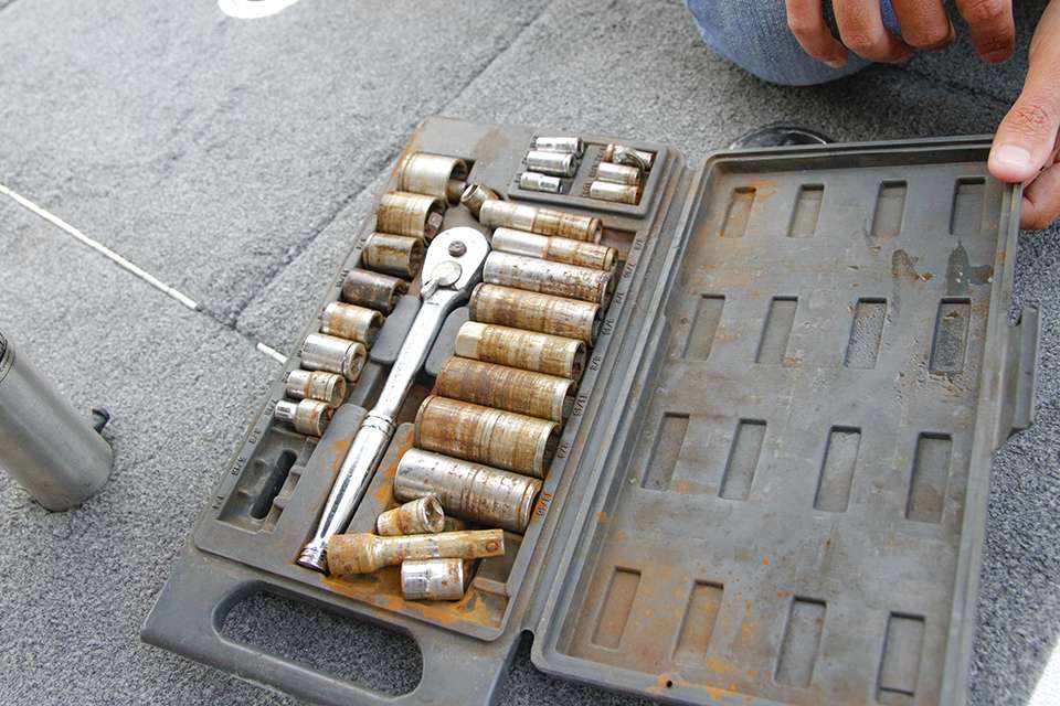 He cracks open his ratchet set, which has enough fittings to tighten any bolt or nut on his boat.