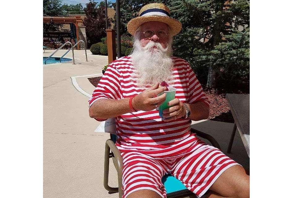 During his offseason, Santa likes to warm up in the sun but have a cool drink with a little umbrella handy.