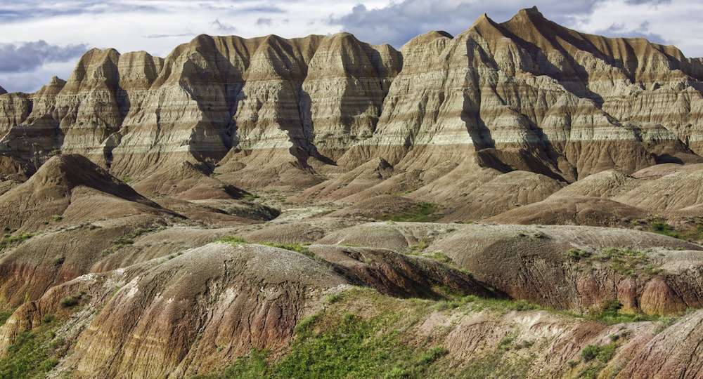 â¦each stripe is a layer of sediment laid down through millions and millions of years. Erosion knocks about an inch a year off this place, in fact all of it has been shaped by water.
