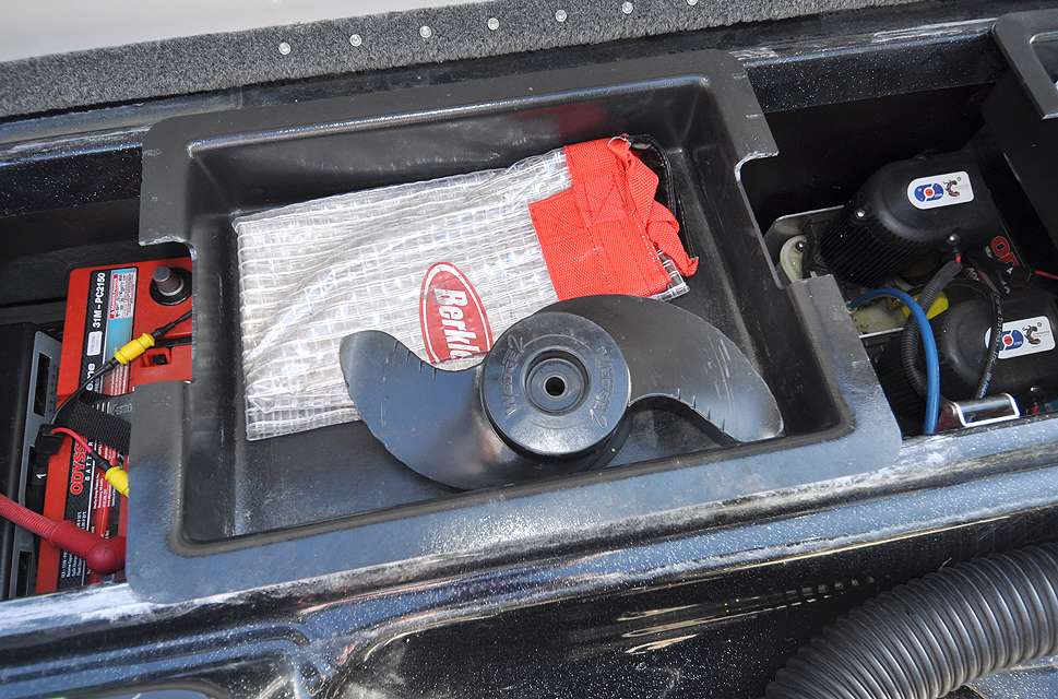 One tray holds a spare trolling motor prop and a fish bag.

