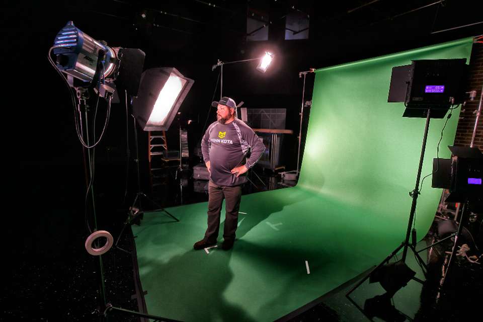 Horne is shot in front of the green screen, which allows editors to fill in the background.