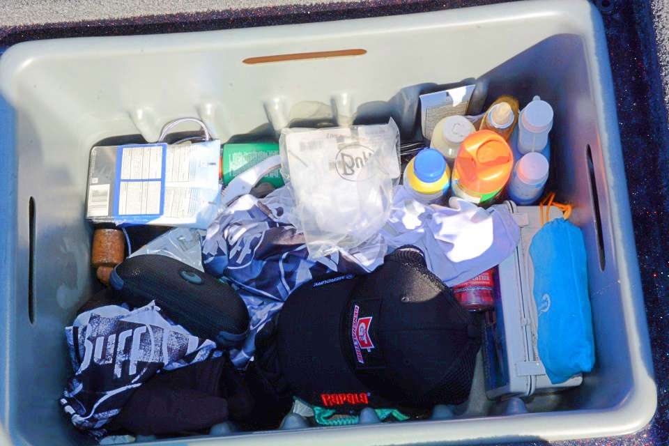 Behind the driver seat is storage reserved for fighting the elements, including the bottle of vanilla spray in the upper right corner. âI used it last year at Lake Dardanelle, where the bug spray wouldnât even repel the gnats.â Buff head and neckwear and other related items are nearby. 
