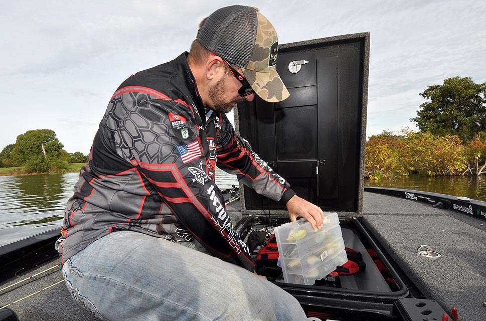 Mullins fetches a flat box filled with crankbaits from his boat locker.