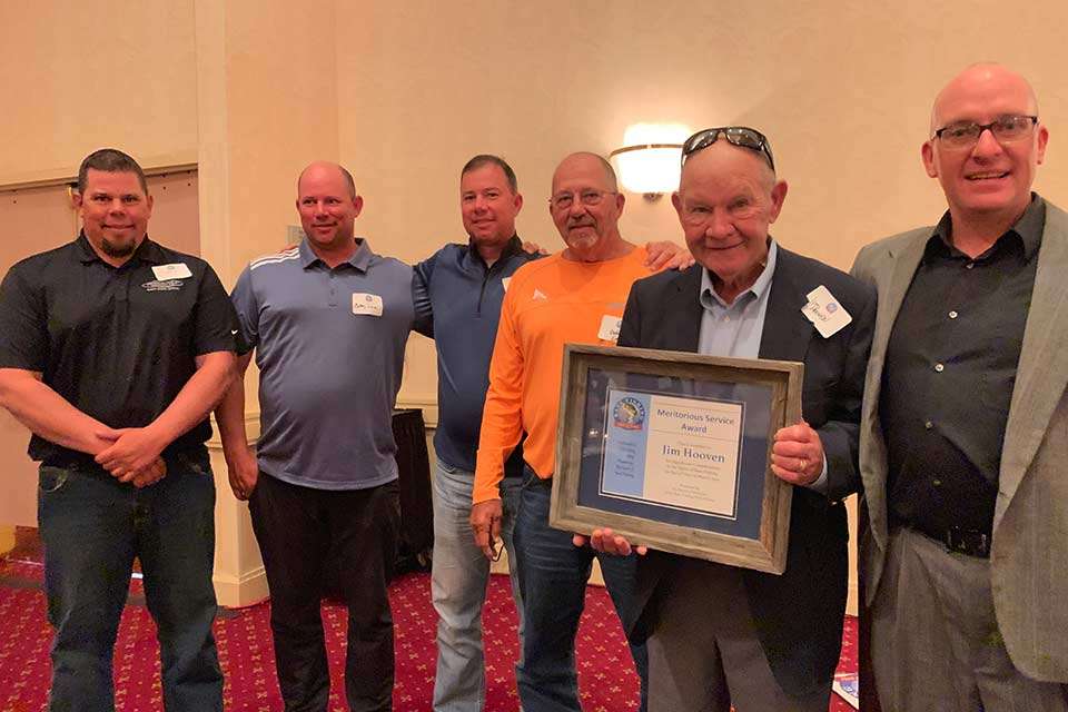 On Thursday night at the Bass Fishing Hall of Fame reception, Jim Hooven was honored with a Meritorious Service Award. Hooven was surrounded by son, Jayson (right), and some of the anglers who found great success after coming up in his Lakeland Bassmasters club, the largest in the country. From left are Classic champ Chris Lane and brothers Bobby Lane and Arnie Lane, along with their father, Robert Lane Sr.