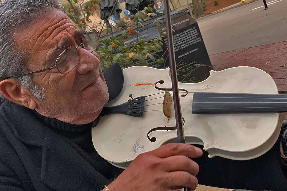 In Market Square, a popular spot with restaurants and shops, this man plays the violin for visitors. He came from Baghdad, Iran, and said his name was Abdul Kareem, though he had trouble spelling it. 
