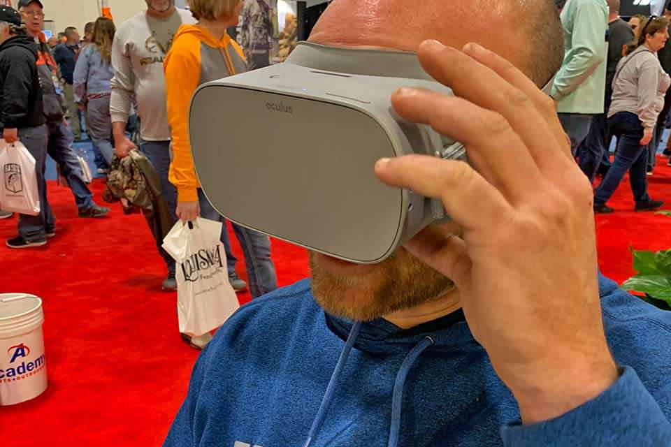 At Bass Cat Boats booth, this guy was too busy with a virtual reality trip down the river to notice anyone tapping him on the shoulder.