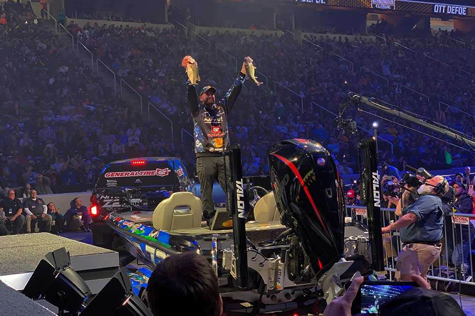Ott DeFoe enters the arena and shows off his fish to the crowd cheering wildly for their hometown favorite. DeFoe lives in Blaine on the Holston River, 20 miles from the weigh-in venue.