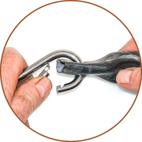 Squeeze the carabiner through the hole and repeat until you have three lengths installed. Add a fourth chain, if necessary.