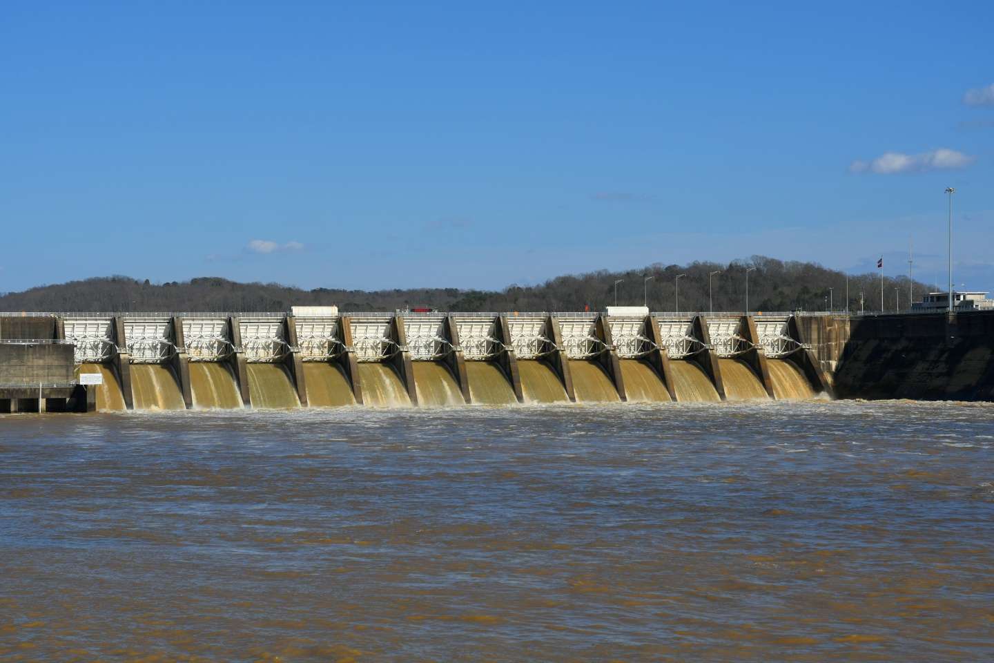 At the opposite end is Fort Loudoun Dam, the uppermost of the Tennessee Valley Authority Dams on the Tennessee River, which winds 652 miles from Knoxville, into northern Alabama, and back up to West Tennessee and into Kentucky Lake. The dam is 122 feet high and stretches 4,190 feet across the river. To the right is the lock chamber that provides navigation into Watts Bar Lake. 
