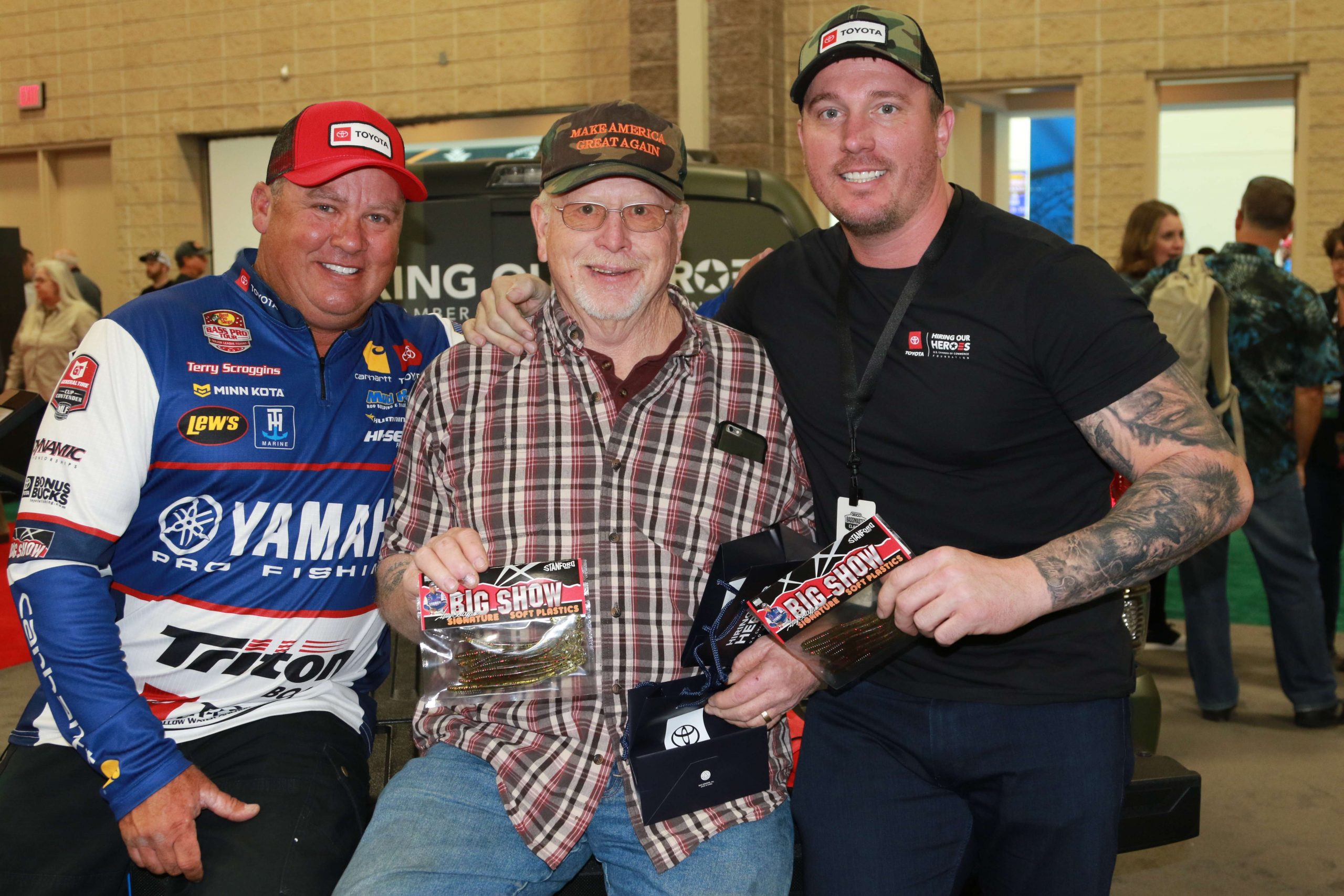 Garage lure maker Terry Scroggins, left, and Medal of Honor winner Dakota Meyer, right share a moment with Vietnam veteran Kenneth Lowe. Scroggins made special edition baits for Toyotaâs veteranâs recognition effort.