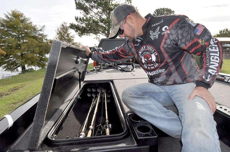 Mullins opens the large rod locker on the passenger side of his boat.
