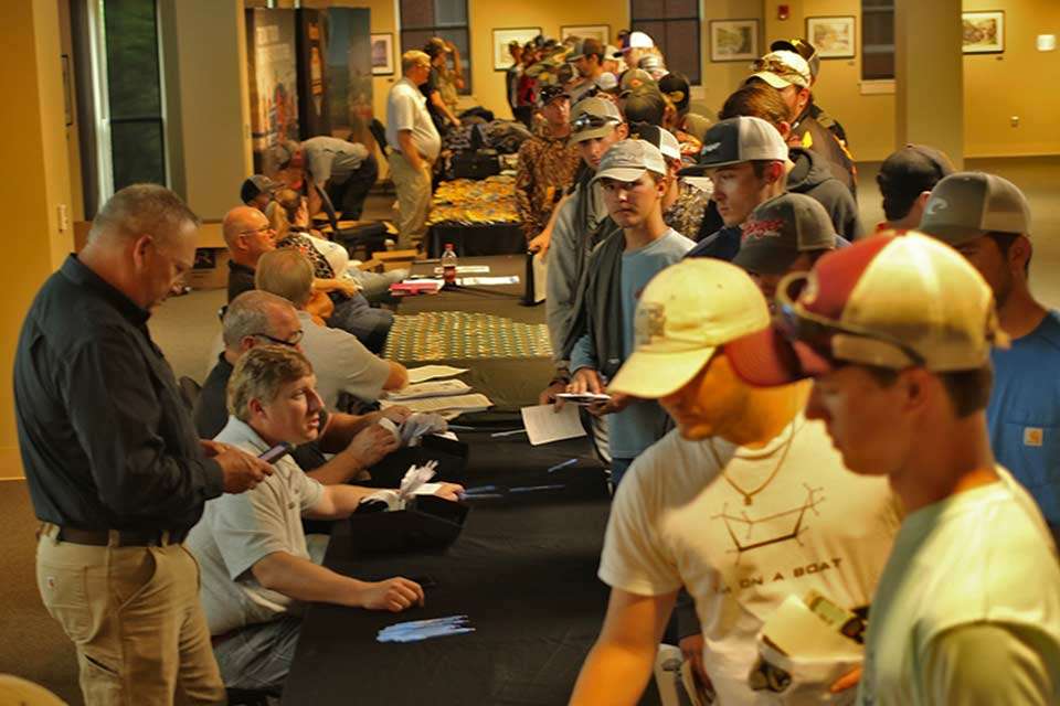 Jon Stewart (standing) and Hank Weldon (seated) helped the lengthy line of anglers getting signed in.