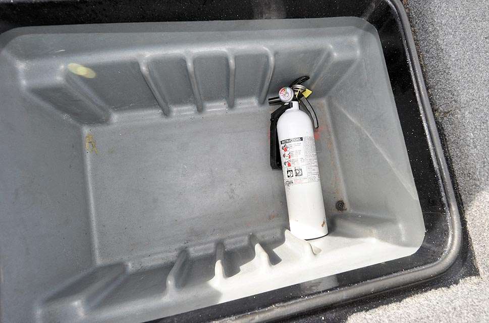 Inside is the fire extinguisher. The slots are usually filled with tackle boxes, but they have been removed prior to selling the boat.

