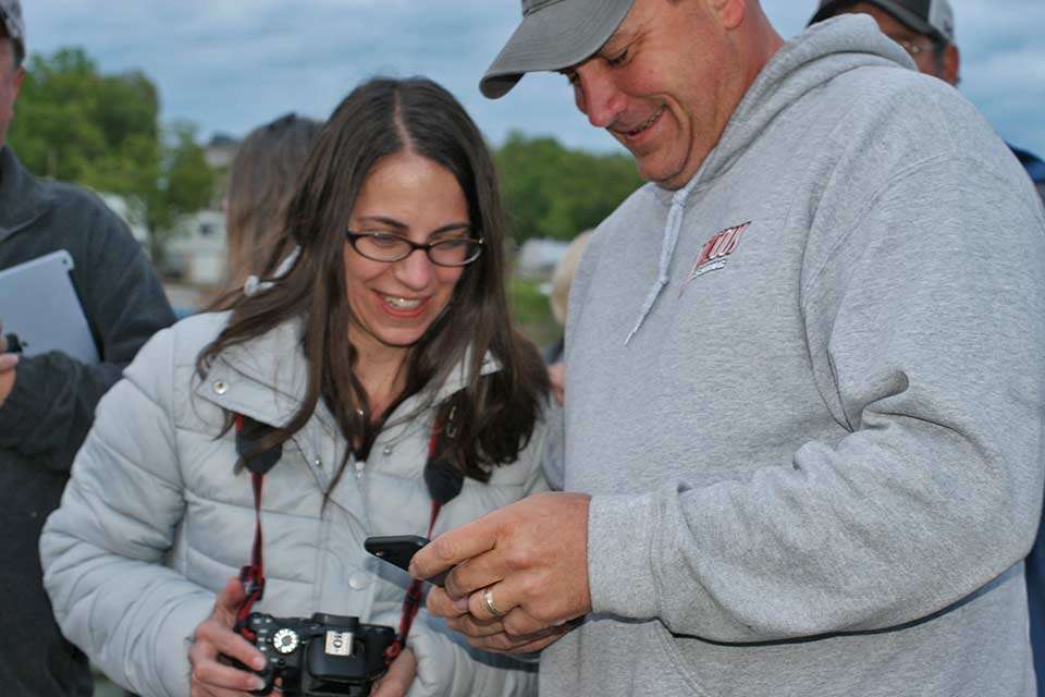 With the anglers off, Kara and Scott Christy of Chicago look over their photos. Scott served as his sonâs high school coach and now volunteers to help B.A.S.S. at events in which his son competes.