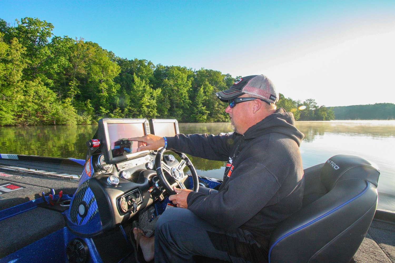 Jamie Hartman, like many professional anglers, has a love/hate relationship with bed fishing. âThereâs nothing more exciting than spotting a big bass up shallow on its spawning bed,â heâll tell you. âBut spawning bass can drive you absolutely crazy, too â theyâre driven by their need to procreate rather than hunger, so their hormones are raging and their behavior can be wildly unpredictable. Some spawners will smash your lure the instant it enters their nest; others seem totally oblivious to your presentations. That rock song âShould I Stay Or Should I Go?â by The Clash pretty much sums up whatâs constantly on your mind when youâre on a bed-fishing pattern in a tournament. When youâre 8 feet away from a fish that could bump up your weight total and net you a sizable paycheck, you naturally want to try every trick in the book to make it bite, but all the while that clock is going tick, tock, tick, tockâ¦â If bed fishing drives you crazy, too, hopefully what follows can bring some sense of order to the mysteries of the spawning season.
<p>

7 HOURS LEFT<br>
<b>6:38 a.m.</b> Itâs 55 degrees and clear when we arrive at Lake L. Hartman pulls several Cashion rods equipped with Lewâs and Shimano reels from storage. What pattern does he anticipate will be operative today? âBass donât all spawn at once, so some fish could be spawning while others are in the immediate postspawn phase. Either way, they should be shallow. My preference, and frankly my greatest strength, as a tournament angler is offshore fishing, but Iâll deal with whatever conditions I find.â<br>
<b>6:55 a.m.</b> We launch the Nitro. Lake L is dead calm. Hartman checks the water temp: 70 degrees. âThatâs leaning more toward postspawn, but the lake looks pretty clear, so if there are any bedding fish, we should be able to see âem. Having no cloud cover, I want to hit some shady spots first.â <br>
<b>7 a.m.</b> Hartman idles into a nearby cove and makes his first casts of the day with a bone-colored Heddon Zara Spook topwater stickbait. âPostspawn bass are usually sluggish, but theyâll hit a slow-moving surface bait like this Spook.â He scans the bottom for light-colored patches indicating spawning beds but doesnât spot any. <br>
<b>7:06 a.m.</b> Some baitfish are flipping on the surface. Hartman points to a light patch beneath an overhanging bush. âThat looks like a bed, but there are no fish on it.â <br>
<b>7:11 a.m.</b> Hartman moves a Â­quarter-mile uplake and dog-walks the Spook around the mouth of a short tributary arm. <br>
<b>7:14 a.m.</b> He switches to a half-ounce white Recon bladed jig with a matching Tattle Tail trailer, both by Riot Baits. <br>
<b>7:15 a.m.</b> Hartman rigs a green pumpkin Riot Baits Fuzzy Beaver creature on a 4/0 straight-shank hook with a 3/8-ounce tungsten sinker, unpegged. âI donât peg my sinkers during spawning season. I donât want the fish to feel any weight when it picks up the lure to carry it off the nest.â He flips the creature into a laydown tree. <br>
<b>7:17 a.m.</b> Back to the bladed jig. He spots a keeper fish on a bed and marks its waypoint on his GPS. âIâll check back here later to see if his big girlfriend has moved onto the nest.â
<b>7:19 a.m.</b> Hartman moves to the back of the cove and chunks a Strike King KVD 1.5 squarebill crankbait (copper perch) to shoreline cover. <br>





<b>7:24 a.m.</b> He flips the creature to a submerged tree. <br>
<b>7:37 a.m.</b> Moving to the opposite shore of the cove, Hartman flips the creature to a series of laydowns. âThis cover looks good from a distance, but a lot of it is really shallow.â <br>
<b>7:51 a.m.</b> Hartman races to the lower end of the lake and flips scattered wood with a generic green pumpkin brush hog creature.
<p>

6 HOURS LEFT<br>
<b>7:55 a.m.</b> Nearing the dam, Hartman cranks riprap with the squarebill. âThese rocks are mainly piled up along shore and donât run out into the lake very far.â <br>
<b>8:01 a.m.</b> He pitches the brush hog to the dam, gets a tap, swings and misses. âJust nipped the tail.â <br>
<b>8:06 a.m.</b> Hartman cranks the 1.5 parallel to the dam. âIt drops off to 12 feet fast here, and this lure runs too shallow to hit bottom. A squarebill is pretty much useless if it isnât deflecting off something.â <br>
