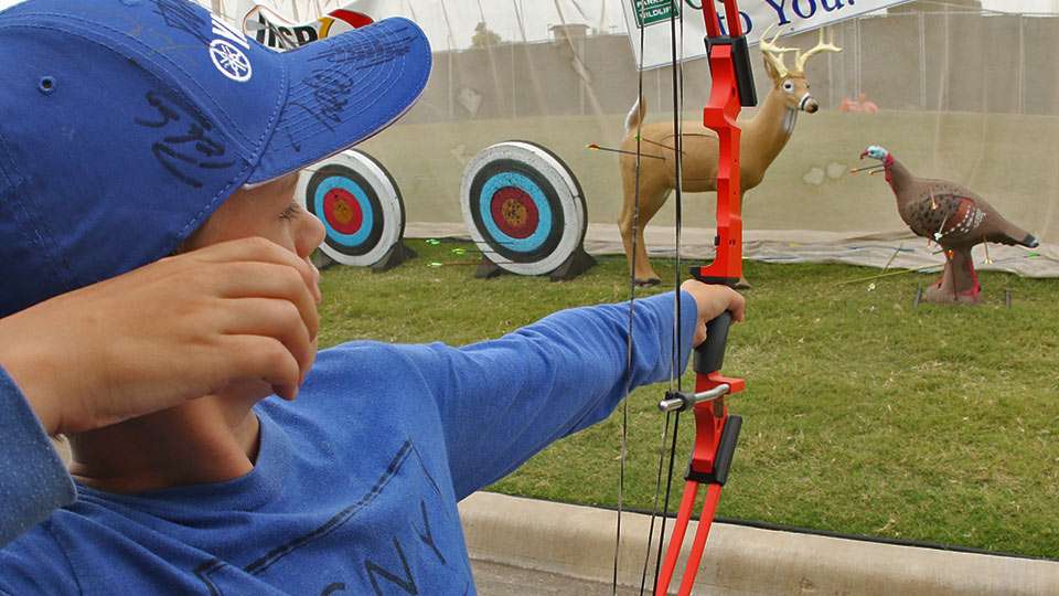 The Get Outside booth, which has partnered with the National Archery in Schools Program, gives youth a chance to shoot at targets.
