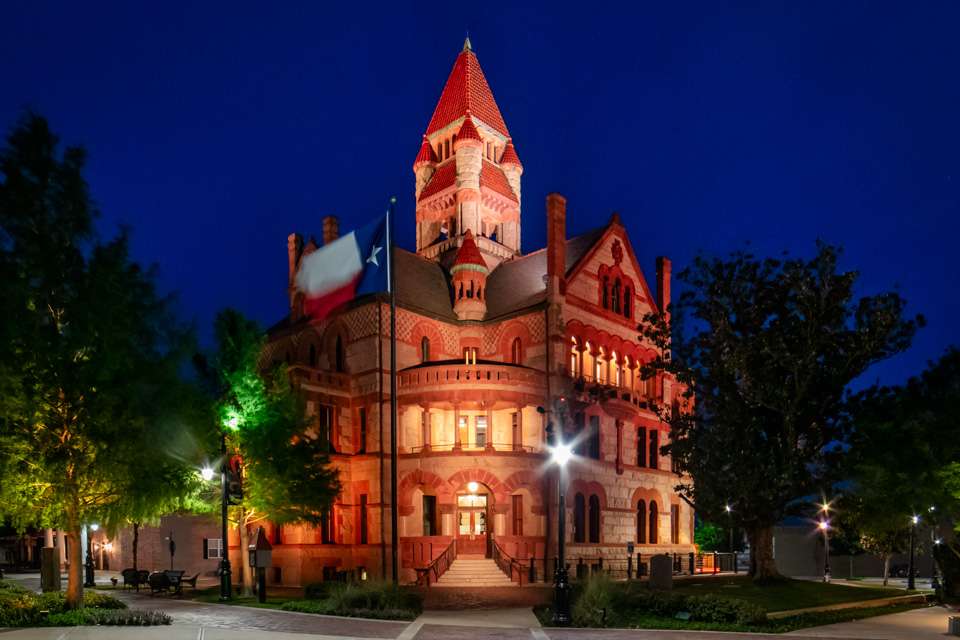 The centerpiece of the square, however, is the amazing Hopkins County Courthouse, which was built in 1895. The town lights the huge stone edifice at night, with constantly changing colors playing across the red granite.
