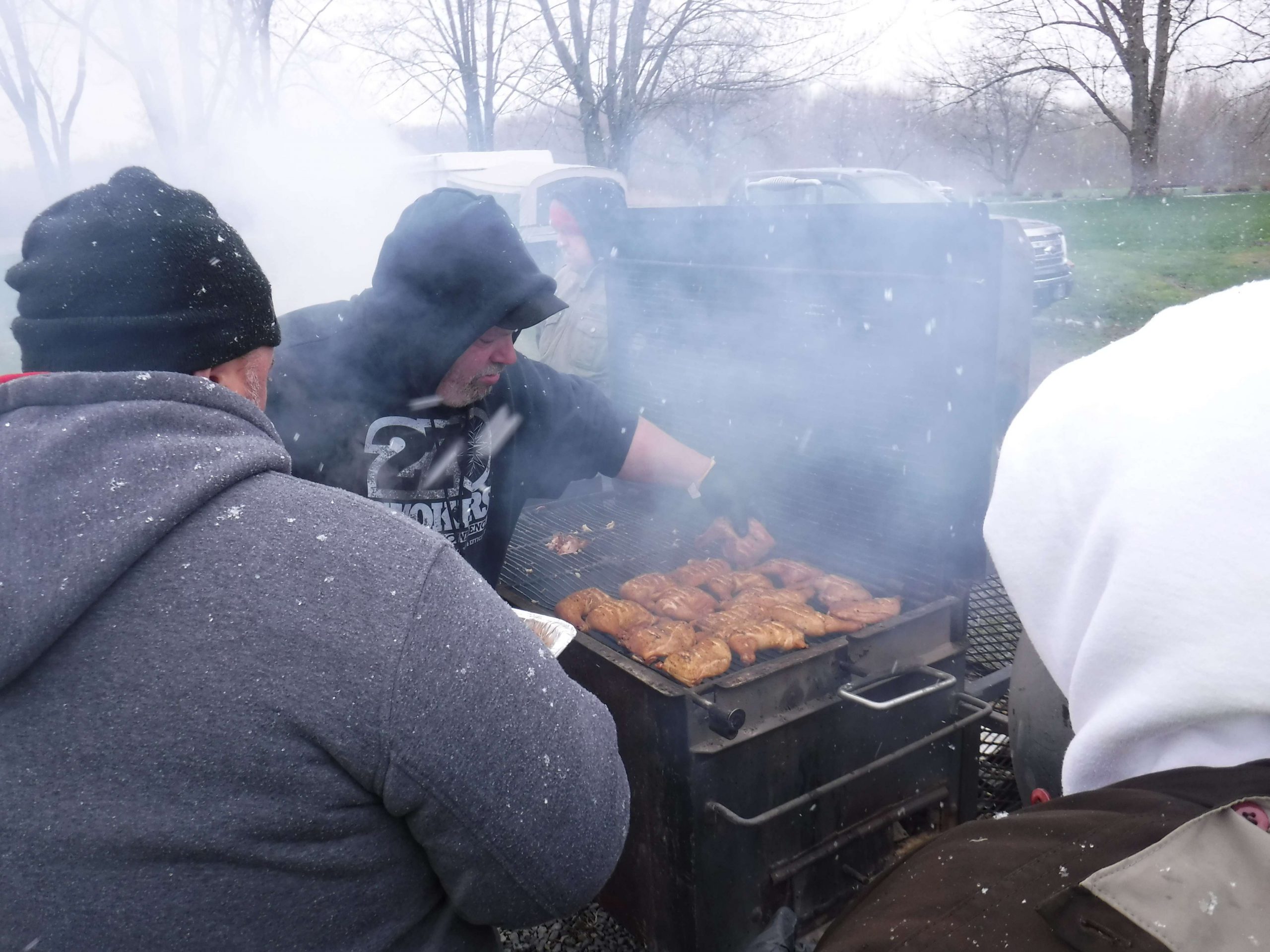 The Barbeque Crew at work. Every year this crew that competes in barbecue competitions cooks for the volunteers. Yes, that is snowflakes with wind gusts at times of 10 to 20 mph.