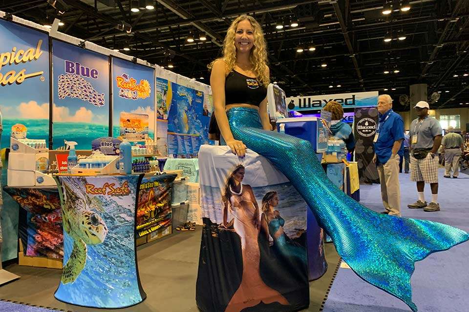 Other booths drew interest with live models. A mermaid helps spread the word of Tropical Seas Blue, an ice chest and locker deodorizer and cleaner.