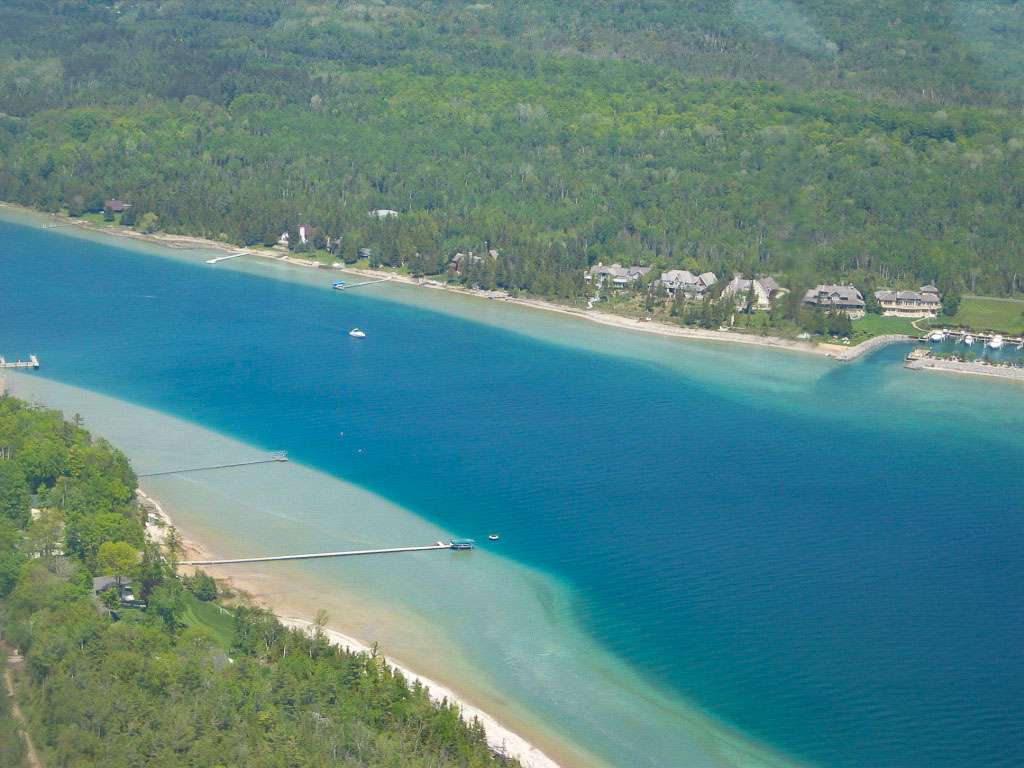 <h4>9. Lake Charlevoix, Michigan </h4> <i> [17,200 acres] </i><br><br> The third-largest lake in the Wolverine State, Charlevoix supports 100 species of fish, from trout and salmon to smallmouth and largemouth bass. The bass relate to a shallow ledge that rims the entire 56-mile shoreline. Fourteen club tournaments in 2018 weighed 1,110 smallmouth and 11 largemouth. There were 145 bass over 4 pounds, with an average weight of 3.23 pounds. The average weight for the big bass was 4.85 pounds. The heaviest of these went 6.05 pounds.
