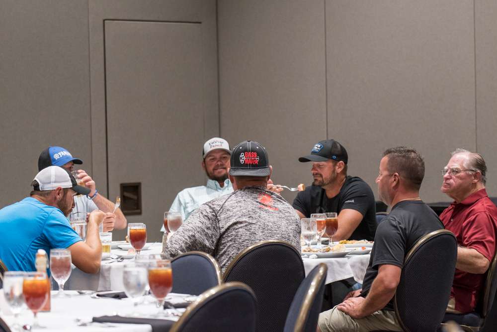 Elite anglers, friends, and super marshals gather around to eat, relax, and socialize.
