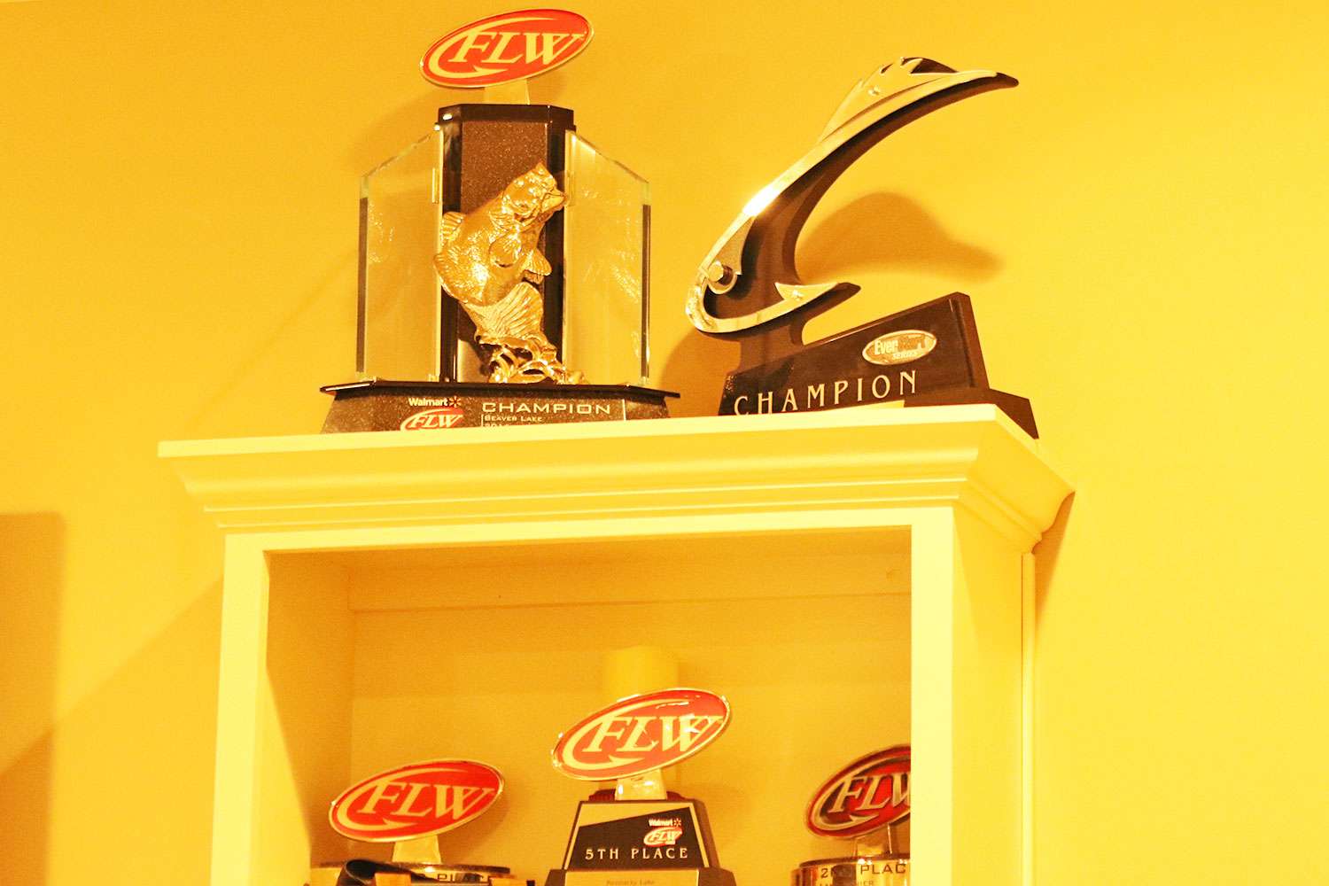 Two of his championship trophies at the top. 