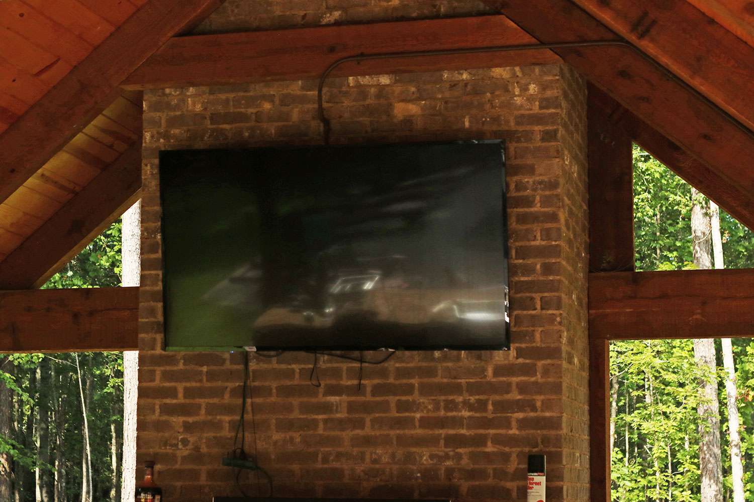 Of course there's a TV mounted above the outdoor fireplace in case Alabama football is taking place. 
