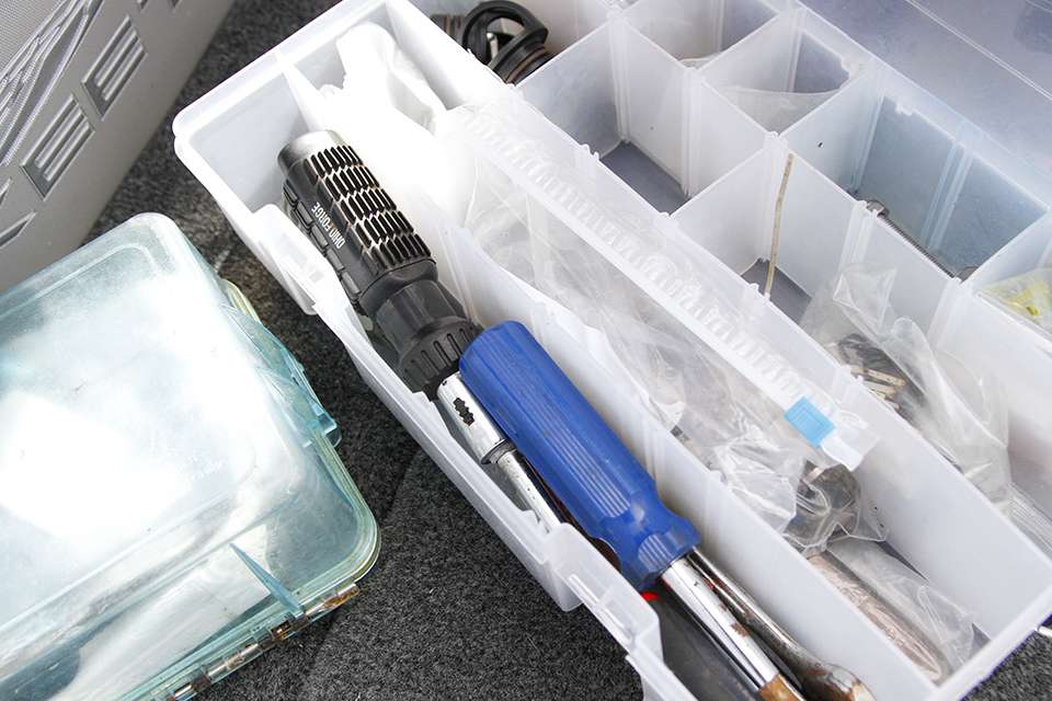 He has a tacklebox of tools as well - screwdrivers, drill bits and more.