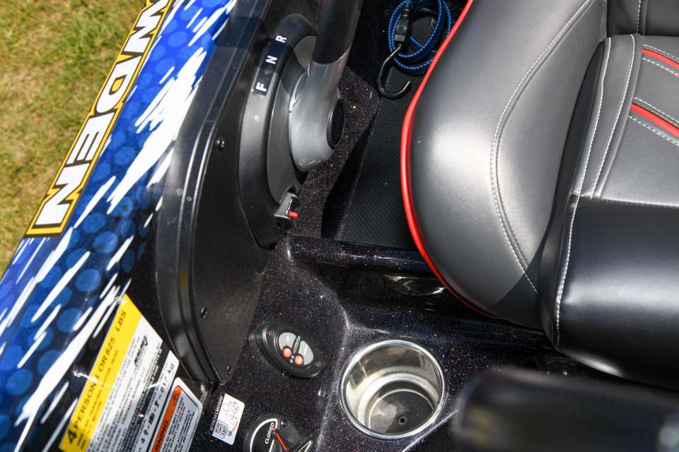 A cupholder to the right of the driverâs seat allows him to keep drinks handy, while a storage shelf holds a rope for use when tying to a dock.
