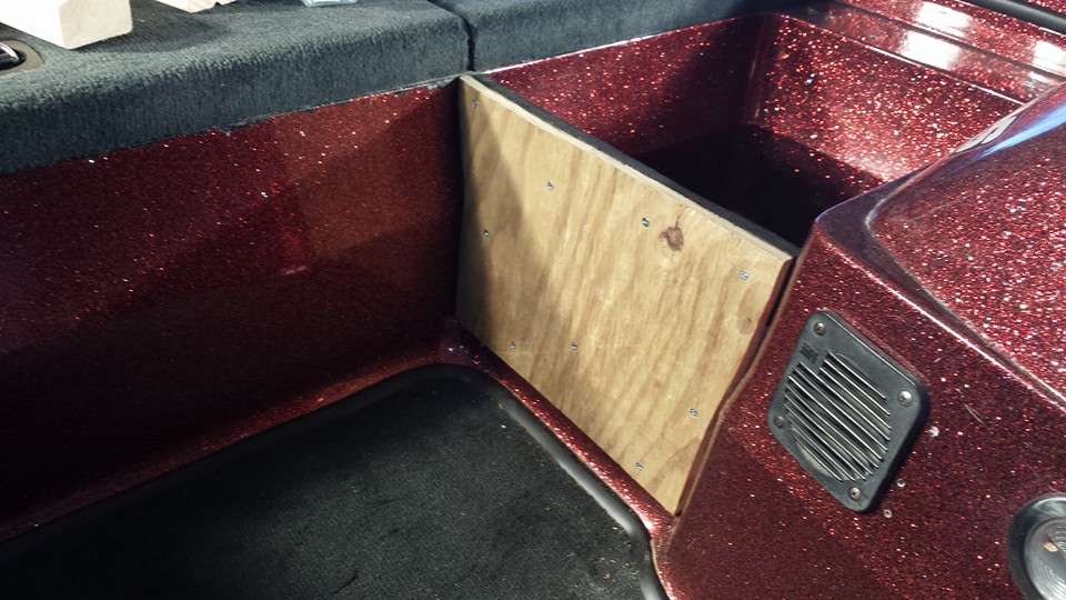 I reinforced the starboard side with three pieces of plywood and screwed them together. These three boards were attached to the fiberglass with four metal brackets. The area in front of the console was the perfect size to add a removable Coleman cooler.
