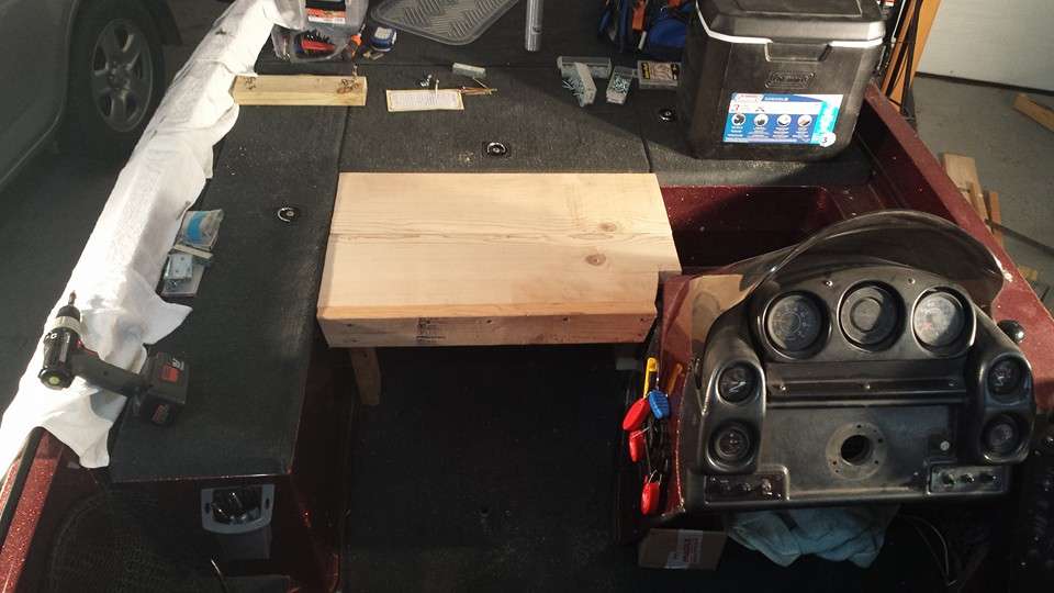 With the necessary strength needed to support my weight and to match the other rod lockers height, two additional 2x12 boards were used on the addition. I used a jig saw to cut one corner of the board to have adequate room around the console and add new carpet.