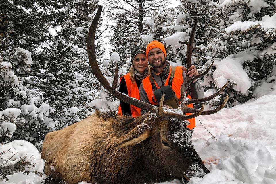 Brandon Palaniuk of Idaho describes his self-guided hunt that went down to the final day and a half with other hunters everywhere. âThe good news was that none of them were leaving their vehicles. We spotted a herd of elk at daylight as they started to slip into the timber â¦ I told Tiff that I had an idea where they were headed so we bundled up and took off. Three miles later we started to finally cut tracks and as I came around a big set of trees, I look up the hill and there he is 30 yards in front of me, bedded down. He jumps up as I jack one in the chamber and the rest is history! Weâre eating good in 2020.â